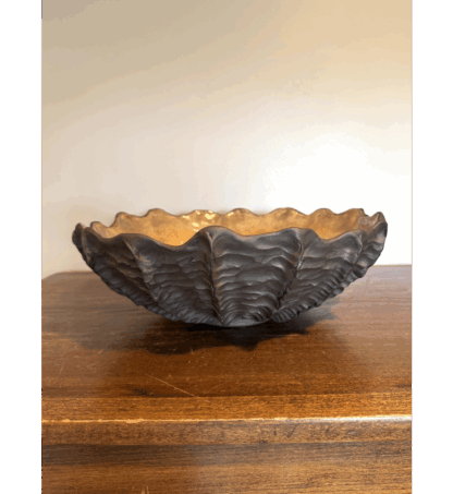 Black seashell bowl with gold interior